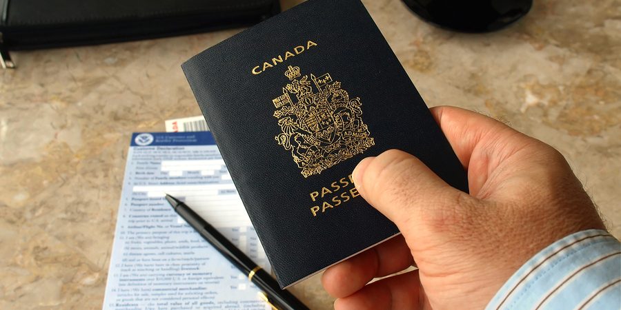 Businessman holding Canadian passport